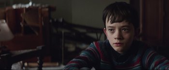 Movie still from “A Monster Calls” (2016), directed by J.A. Bayona – A young boy is sitting in front of a table; Close Up shot, High angle