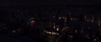 Movie still from “A Monster Calls” (2016), directed by J.A. Bayona – An aerial view of a residential neighborhood at night; Extreme Wide shot, High angle