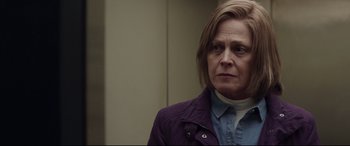 Movie still from “A Monster Calls” (2016), directed by J.A. Bayona – A woman in a purple jacket is standing in a room; Close Up shot, Over the shoulder angle