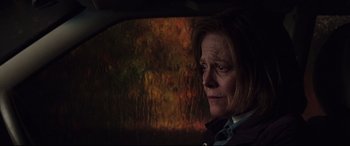 Movie still from “A Monster Calls” (2016), directed by J.A. Bayona – A woman sitting in the back seat of a car looking out the window; Close Up shot, Low angle
