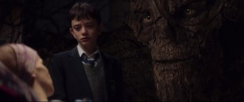Movie still from “A Monster Calls” (2016), directed by J.A. Bayona – A young boy standing in front of a tree; Close Up shot, Low angle
