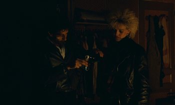 Movie still from “So Long, Stooge” (1983), directed by Claude Berri – A man and a woman looking at a cell phone; Medium shot, High angle