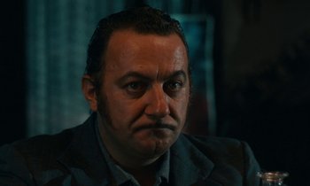 Movie still from “So Long, Stooge” (1983), directed by Claude Berri – A person wearing a jacket; Close Up shot, Low angle