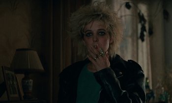 Movie still from “So Long, Stooge” (1983), directed by Claude Berri – A woman with a cigarette in her mouth; Close Up shot, Over the shoulder angle