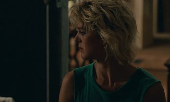 Movie still from “So Long, Stooge” (1983), directed by Claude Berri – A woman in a green shirt looking to the side; Close Up shot, Over the shoulder angle