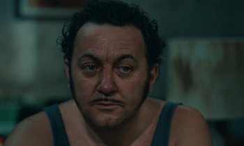 Movie still from “So Long, Stooge” (1983), directed by Claude Berri – A person wearing a tank top; Close Up shot, Low angle