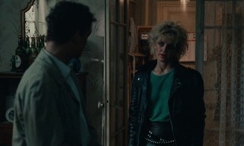 Movie still from “So Long, Stooge” (1983), directed by Claude Berri – A man and a woman standing next to each other in front of a door; Medium shot, Over the shoulder angle