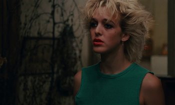 Movie still from “So Long, Stooge” (1983), directed by Claude Berri – A woman in a green shirt is looking at the camera; Close Up shot, Low angle