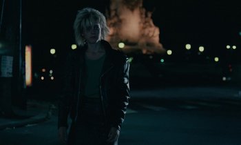 Movie still from “So Long, Stooge” (1983), directed by Claude Berri – A woman standing in the street at night; Medium shot, Low angle