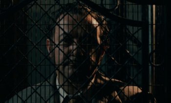 Movie still from “So Long, Stooge” (1983), directed by Claude Berri – A person behind a fence; Close Up shot, Low angle