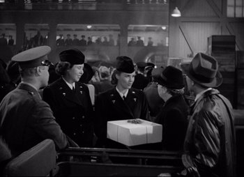 Movie still from “So Proudly We Hail” (1990), directed by Lionel Chetwynd – A black and white photo of a group of women in uniform; Medium shot, Over the shoulder angle