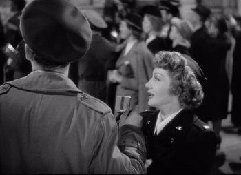 Movie still from “So Proudly We Hail” (1990), directed by Lionel Chetwynd – An old photo of a woman talking to a man; Medium shot, Over the shoulder angle