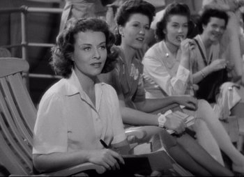 Movie still from “So Proudly We Hail” (1990), directed by Lionel Chetwynd – A black and white photo of a group of women sitting on steps; Medium shot, High angle