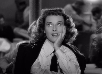 Movie still from “So Proudly We Hail” (1990), directed by Lionel Chetwynd – An old photo of a woman in a suit and tie; Close Up shot, High angle