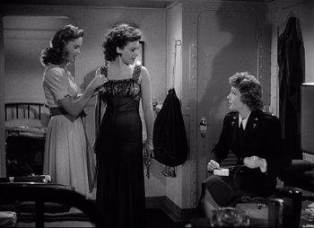 Movie still from “So Proudly We Hail” (1990), directed by Lionel Chetwynd – A group of women standing next to each other in a room; Medium shot, Over the shoulder angle