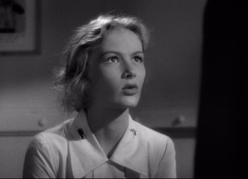 Movie still from “So Proudly We Hail” (1990), directed by Lionel Chetwynd – A black - and - white photo of a woman looking up; Close Up shot, Low angle
