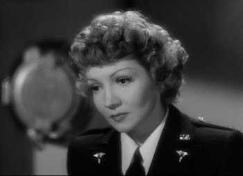 Movie still from “So Proudly We Hail” (1990), directed by Lionel Chetwynd – An old photo of a woman in a military uniform; Close Up shot, Low angle