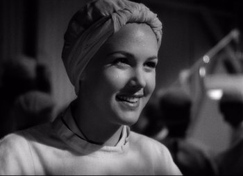 Movie still from “So Proudly We Hail” (1990), directed by Lionel Chetwynd – A black and white photo of a woman wearing a turban; Close Up shot, Low angle