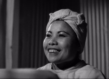 Movie still from “So Proudly We Hail” (1990), directed by Lionel Chetwynd – A black and white photo of a woman wearing a turban; Close Up shot, Low angle