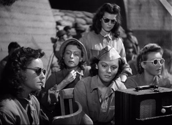 Movie still from “So Proudly We Hail” (1990), directed by Lionel Chetwynd – A black and white photo of a group of women; Medium shot, Low angle