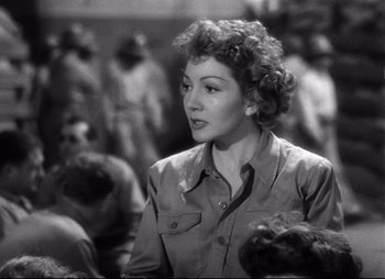 Movie still from “So Proudly We Hail” (1990), directed by Lionel Chetwynd – An old photo of a woman in a crowd of people; Close Up shot, Over the shoulder angle
