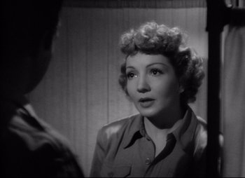 Movie still from “So Proudly We Hail” (1990), directed by Lionel Chetwynd – A black - and - white photo of a woman looking at a mirror; Close Up shot, Over the shoulder angle