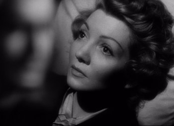 Movie still from “So Proudly We Hail” (1990), directed by Lionel Chetwynd – An old black and white photo of a woman; Close Up shot, High angle