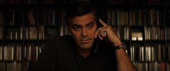 Movie still from “Solaris” (2002), directed by Steven Soderbergh – A man is talking on a cell phone in front of a bookshelf; Close Up shot, Over the shoulder angle