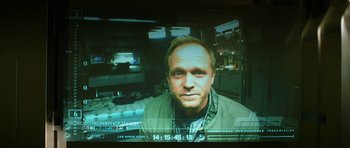Movie still from “Solaris” (2002), directed by Steven Soderbergh – A man's face on a television screen; Close Up shot, Over the shoulder angle