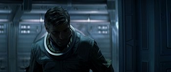 Movie still from “Solaris” (2002), directed by Steven Soderbergh – A man wearing a space suit in a dark room; Close Up shot, Low angle