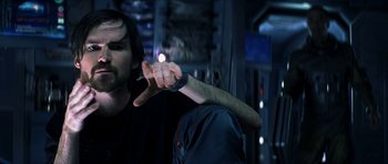 Movie still from “Solaris” (2002), directed by Steven Soderbergh – A man holding his arm up to the side of his face; Close Up shot, Over the shoulder angle