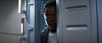 Movie still from “Solaris” (2002), directed by Steven Soderbergh – A young man standing in front of an open door; Close Up shot, Low angle