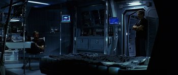 Movie still from “Solaris” (2002), directed by Steven Soderbergh – A room that has a tv on the wall; Wide shot, High angle