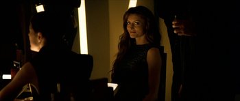 Movie still from “Solaris” (2002), directed by Steven Soderbergh – A beautiful young lady standing in front of a mirror; Medium shot, Over the shoulder angle