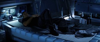 Movie still from “Solaris” (2002), directed by Steven Soderbergh – A person laying on a computer keyboard in the dark; Medium shot, Overhead angle