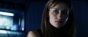 Movie still from “Solaris” (2002), directed by Steven Soderbergh – A person with long brown hair; Close Up shot, Over the shoulder angle
