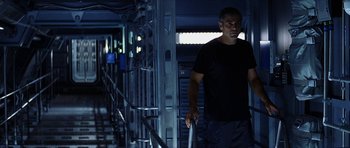 Movie still from “Solaris” (2002), directed by Steven Soderbergh – A man in a black shirt is walking down a ramp; Medium shot, Low angle
