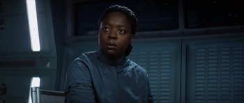 Movie still from “Solaris” (2002), directed by Steven Soderbergh – A woman in a blue shirt is looking at the camera; Close Up shot, Over the shoulder angle