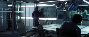 Movie still from “Solaris” (2002), directed by Steven Soderbergh – A man standing in front of a conference room table; Wide shot, High angle