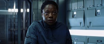 Movie still from “Solaris” (2002), directed by Steven Soderbergh – A woman in a black shirt is looking at the camera; Close Up shot, Over the shoulder angle