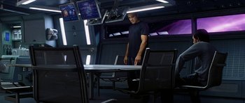 Movie still from “Solaris” (2002), directed by Steven Soderbergh – A man standing in front of a table in a room; Medium shot, High angle