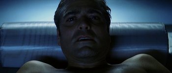 Movie still from “Solaris” (2002), directed by Steven Soderbergh – A man's face in the dark; Close Up shot, Overhead angle