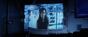 Movie still from “Solaris” (2002), directed by Steven Soderbergh – A woman in a black top is on a screen; Close Up shot, Over the shoulder angle