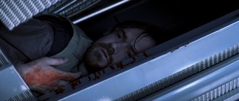 Movie still from “Solaris” (2002), directed by Steven Soderbergh – A man with a beard is laying in a sink; Close Up shot, Overhead angle