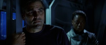 Movie still from “Solaris” (2002), directed by Steven Soderbergh – A man in a black shirt is looking at the camera; Close Up shot, Low angle
