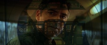 Movie still from “Solaris” (2002), directed by Steven Soderbergh – A man in a suit and tie looking at the camera; Close Up shot, Overhead angle