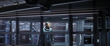 Movie still from “Solaris” (2002), directed by Steven Soderbergh – A man standing in front of a window in a room; Medium shot, Low angle