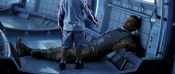 Movie still from “Solaris” (2002), directed by Steven Soderbergh – A man laying on the ground next to a child; Wide shot, High angle