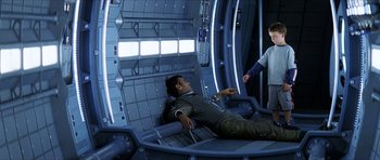 Movie still from “Solaris” (2002), directed by Steven Soderbergh – A man laying on a chair in a room; Wide shot, High angle