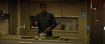 Movie still from “Solaris” (2002), directed by Steven Soderbergh – A man standing in front of a kitchen counter; Medium shot, Low angle